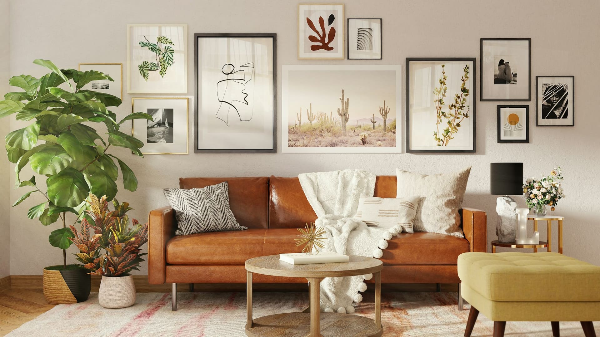 A cognac leather sofa with a cream throw beneath a salon-style wall of botanical prints, with a mustard footstool.