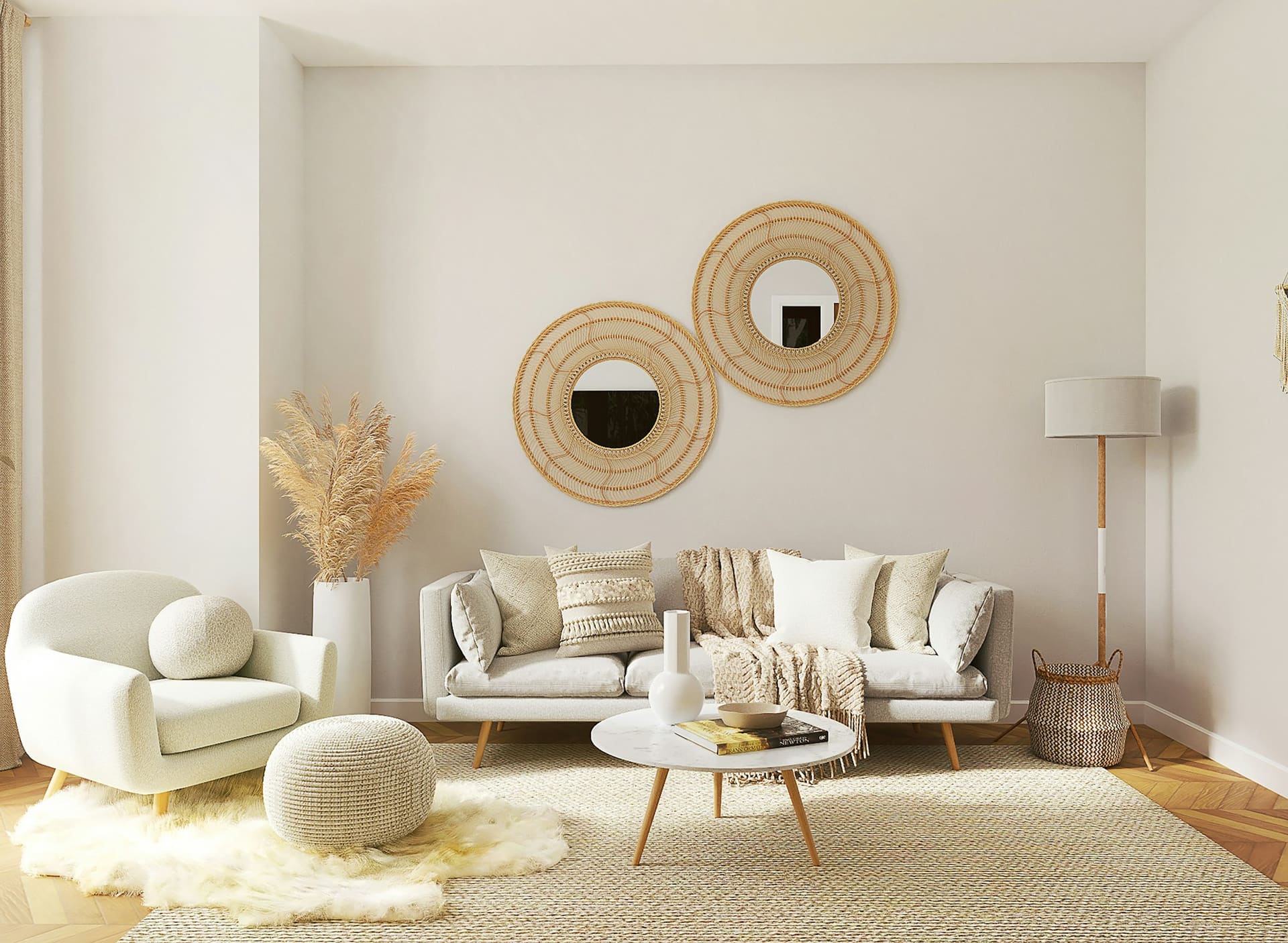 A cream living room with a bouclé armchair, a low linen sofa, two round rattan mirrors on the wall and a sheepskin over a jute rug.