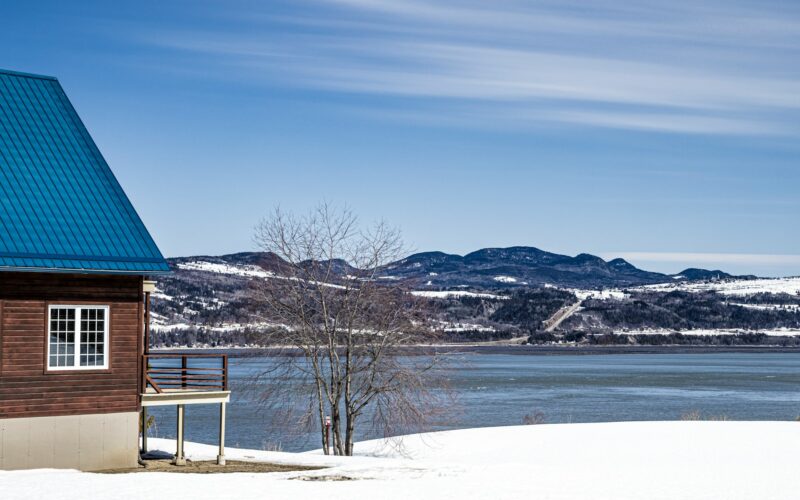 A wooden cabin in northern Quebec on the snowy shore